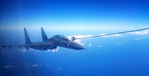 (160925) -- NANJING, Sept. 25, 2016 (Xinhua) -- A Su-30 fighter of the Chinese Air Force gets fueled in the air during a drill, Sept. 25, 2016. The Chinese Air Force on Sunday sent more than 40 aircraft of various types to the West Pacific, via the ...