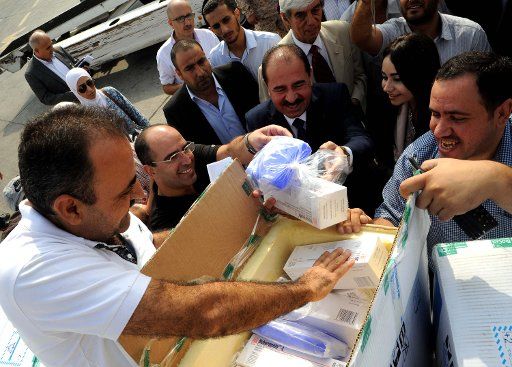 (160830) -- DAMASCUS, Aug. 30, 2016 (Xinhua) -- Medical shipments from Cuba are unloaded at an airport in Damascus, capital of Syria, on Aug. 29, 2016. The two-ton medical shipments from Cuba were the first batch of banking arrangements to settle ...
