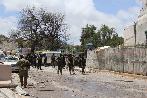 (160830) -- MOGADISHU, Aug. 30, 2016 (Xinhua) -- Security members gather at the explosion site in Mogadishu, capital of Somalia, on Aug. 30, 2016. At least seven people were killed and several others injured in a bomb explosion that hit a popular ...