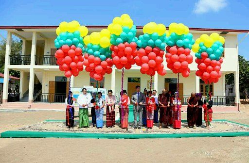 (161020) -- BAGO, Oct. 20, 2016 (Xinhua) -- Chinese Ambassador to Myanmar Hong Liang (C) and officials of U Nu and Daw Mya Ye Foundation cut the ribbon during the donation ceremony of a China-Myanmar friendship school building in Bago region, ...