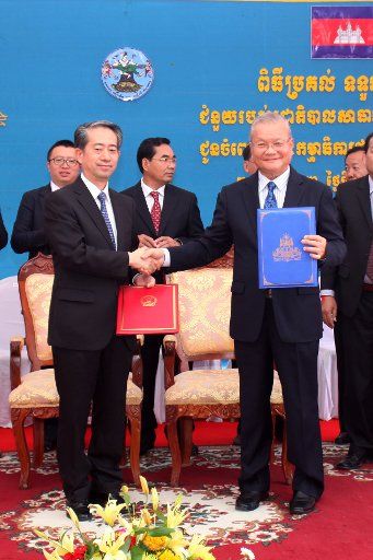 (161220) -- PHNOM PENH, Dec. 20, 2016 (Xinhua) -- Chinese Ambassador to Cambodia Xiong Bo (L) shakes hands with Sik Bun Hok, chairman of the Cambodian National Election Committee during a donation ceremony in Phnom Penh Dec. 20, 2016. China on ...