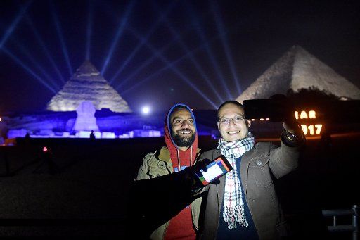 (170101) -- GIZA, Jan. 1, 2017 (Xinhua) -- People take selfies during New Year celebrations in Giza, Egypt, on Jan. 1, 2017. (Xinhua\/Zhao Dingzhe) (djj)