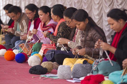 (161126) -- KATHMANDU, Nov. 26, 2016 (Xinhua) -- Women knit woolen rope during the 14th handicraft trade fair and 12th craft competition in Kathmandu, capital of Nepal, Nov. 25, 2016. The five-day fair was opened on Friday. (Xinhua\/Pratap Thapa) (...