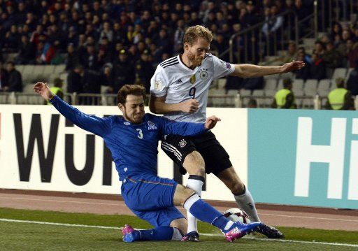 (170327)-- BAKU, March. 26, 2017(Xinhua)-- Andre Schurle (R) of Germany vies with Rahid Amirguliyev of Azerbaijan during the FIFA World Cup 2018 European Qualifiers Group C match between Azerbaijan and Germany in Baku, Azerbaijan, March 26, 2017. ...