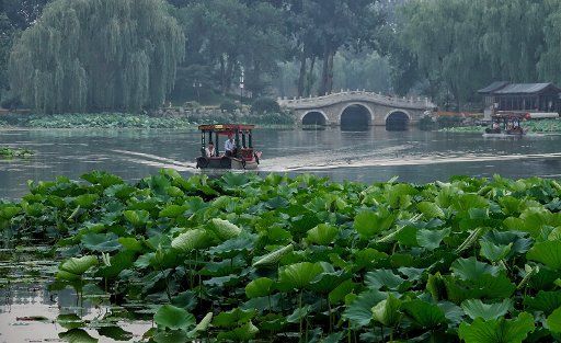 (170619) -- BEIJING, June 19, 2017 (Xinhua) -- Tourists take boats to view lotus flowers at the Yuanmingyuan, or the Old Summer Palace, in Beijing, capital of China, June 18, 2017. (Xinhua\/Li Xin) (ry)