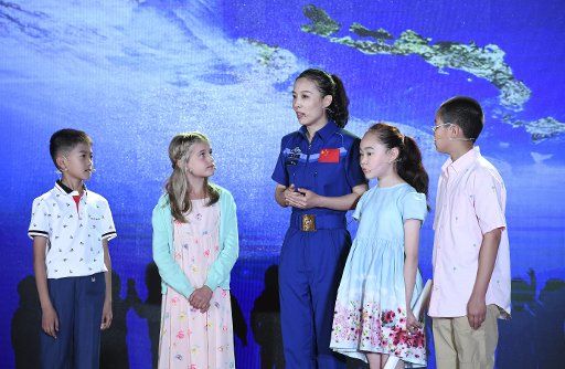 (170606) -- BEIJING, June 6, 2017 (Xinhua) -- Chinese astronaut Wang Yaping (C) talks with children during an event on the 2017 Global Space Exploration Conference in Beijing, capital of China, June 6, 2017. The conference opened Tuesday in Beijing. ...