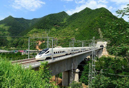 (170709) -- BAOJI, July 9, 2017 (Xinhua) -- Photo taken on July 9, 2017 shows a bullet train running on a bridge in the junction of northwest China\