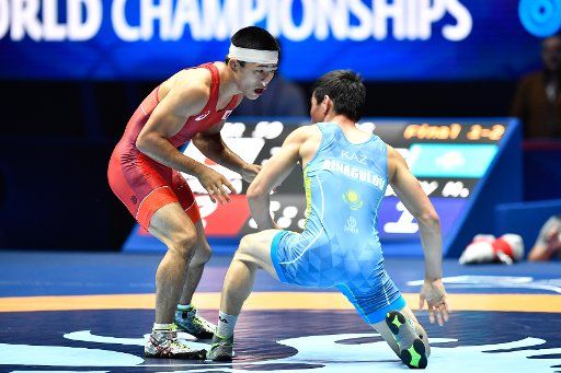 (170823) -- PARIS, Aug. 23, 2017 (Xinhua) -- Kenichiro Fumita (L) of Japan competes with Mirambek Ainagulov of Kazakhstan during the final match of men\