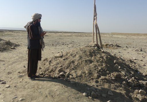 (170911) -- LOGAR (AFGHANISTAN), Sept. 11, 2017 (Xinhua) -- An Afghan man prays in front of a tomb of a victim who was killed in U.S. airstrikes in Khalil Abad village, outskirt of Pul-e-Alam, Afghanistan, Sept. 7, 2017. The Taliban regime collapsed ...