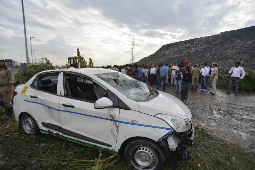 (170901) -- NEW DELHI, Sept. 1, 2017 (Xinhua) -- A car is damaged during the collapse of a garbage landfill in suburb of New Delhi, India on Sept. 1, 2017. A landfill in Indian capital city of New Delhi caved on Friday, killing two and trapping ...