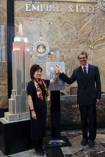 (171004) -- NEW YORK, Oct. 4, 2017 (Xinhua) -- Chinese Consul General in New York Zhang Qiyue (L) and Anthony Malkin, CEO and Chairman of Empire State Realty Trust, flip the switch to light the model of Empire State Building during a ceremonial ...