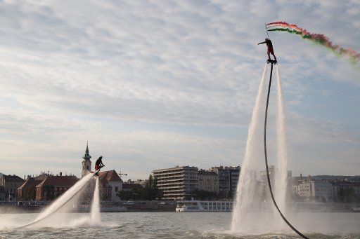 (170930) -- BUDAPEST, Sept. 30, 2017 (Xinhua) -- Flyboard riders perform with water-propelled flyboards on the Danube River in Budapest, Hungary, on Sept. 29, 2017. (Xinhua\/Attila Volgyi)