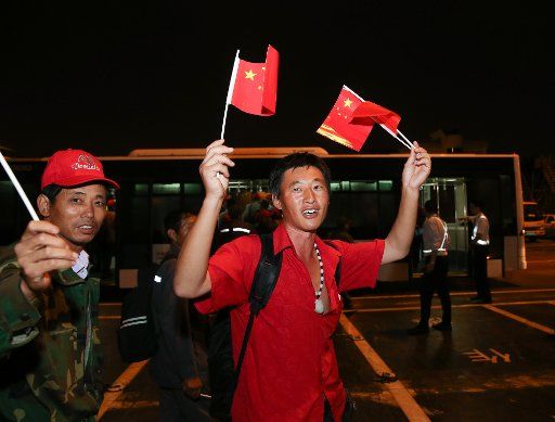(171001) -- SHANGHAI, Oct. 1, 2017 (Xinhua) -- Chinese nationals wave small Chinese national flags as they arrive at Shanghai Hongqiao International Airport in Shanghai, east China, Oct. 1, 2017. Sheltered in Antigua and Barbuda after Hurricane ...