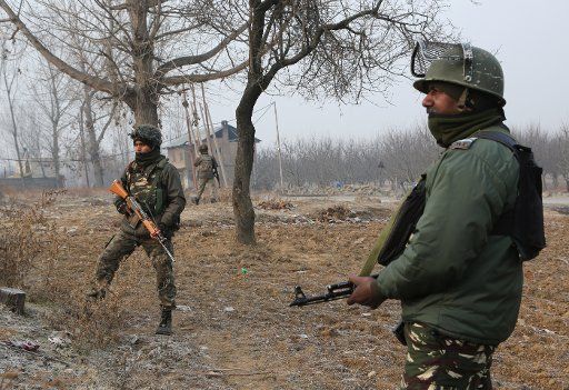 (171231) -- SRINAGAR, Dec. 31, 2017 (Xinhua) -- Indian paramilitary troopers stand guard near a paramilitary camp that was stormed by gunmen, who are believed to be fidayeen (suicide attackers) militants, in Lethpora-Awantipora of district Pulwama, about 26 km south of Srinagar city, summer capital of Indian-controlled Kashmir, Dec. 31, 2017. At least one paramilitary trooper of Central Reserve Police Force (CRPF) was killed and two others wounded early Sunday after militants stormed their camp in restive Indian-controlled Kashmir, police said. (Xinhua\/Javed Dar) (zjl)