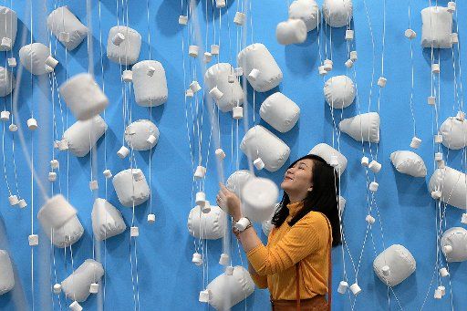 (180211) -- PASAY CITY, Feb. 11, 2018 (Xinhua) -- A woman poses for a photo inside the Marshmallow Room of the Dessert Museum in Pasay City, the Philippines, on Feb. 11, 2018. The Dessert Museum features colorfully decorated snack-themed rooms where visitors are treated with snacks and can learn their history respectively. (Xinhua\/Rouelle Umali) (zjl)