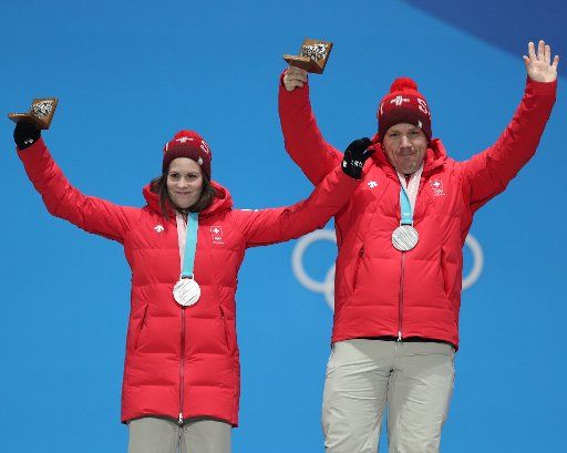 (180214) -- PYEONGCHANG, Feb. 14, 2018 (Xinhua) -- Silver medalists Jenny Perret (L) and Martin Rios of Switzerland celebrate during medal ceremony of the mixed doubles event of curling at 2018 PyeongChang Winter Olympic Games at the Medal Plaza in PyeongChang, South Korea, on Feb. 14, 2018. (Xinhua\/Wu Zhuang)