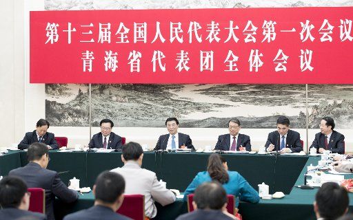 (180312) -- BEIJING, March 12, 2018 (Xinhua) -- Wang Huning, a member of the Standing Committee of the Political Bureau of the Communist Party of China (CPC) Central Committee, joins a panel discussion with the deputies from Qinghai Province at the first session of the 13th National People\
