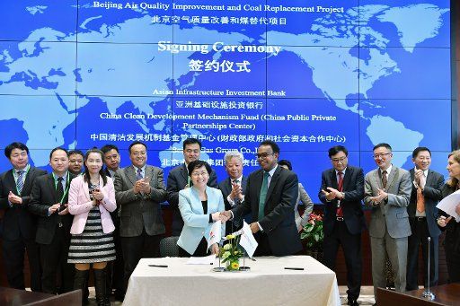 (180319) -- BEIJING, March 19, 2018 (Xinhua) -- The Asian Infrastructure Investment Bank (AIIB) signs a natural gas project with a Chinese company to improve the air quality in Beijing, capital of China, March 19, 2018. It marks the AIIB\
