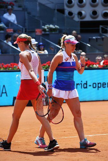(180512) -- MADRID, May 12, 2018 (XINHUA) -- Kristina Mladenovic of France and Timea Babos (R) of Hungary react during the women\