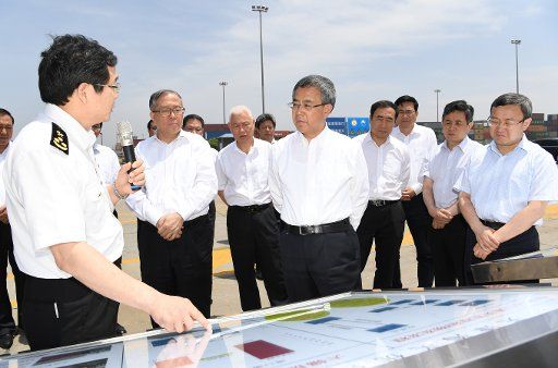 (180608) -- TIANJIN, June 8, 2018 (Xinhua) -- Chinese Vice Premier Hu Chunhua, also a member of the Political Bureau of the Communist Party of China Central Committee, gains the first-hand information about construction of pilot free trade zones during an inspection tour to Tianjin, north China, June 7, 2018. (Xinhua) (wyl)