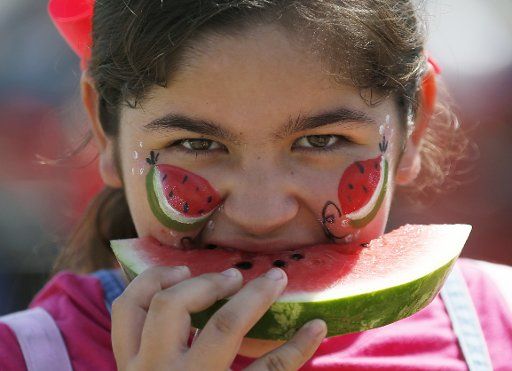 (180730) -- LOS ANGELES, July 30, 2018 (Xinhua) -- A girl enjoys watermelon at the 56th Annual California Watermelon Festival in Los Angeles, the United States on July 29, 2018. The festival features free watermelon games, all-you-can-eat free watermelons, watermelon carving and live entertainment. (Xinhua\/Li Ying) (zxj)