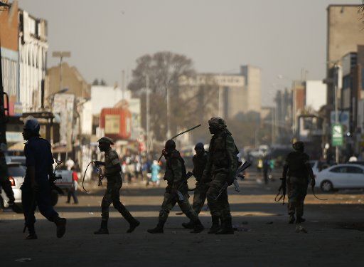 (180801) -- HARARE, Aug. 1, 2018 (Xinhua) -- Soldiers patrol a street in Harare, Zimbabwe, Aug. 1, 2018. Three people died and scores of others were injured Wednesday when protesting opposition supporters clashed with army and police in the capital Harare. Scores of opposition supporters took to the streets of Harare to protest against the delay in announcement of presidential election results as well as alleged rigging of the vote. (Xinhua\/Shaun Jusa)