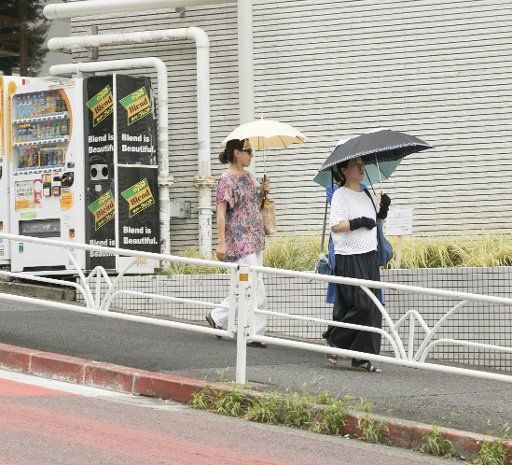 (180802) -- TOKYO, Aug. 2, 2018 (Xinhua) -- People walk with umbrellas in Shibuya, Tokyo, Japan, Aug. 2, 2018. (Xinhua\/Du Xiaoyi) (lrz)