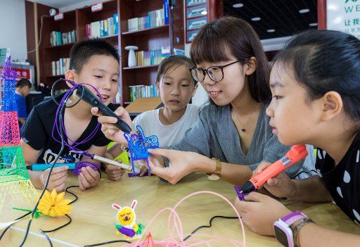 (180808) -- HOHHOT, Aug. 8, 2018 (Xinhua) -- Children learn about 3D printing at a community center in Yuquan District of Hohhot, north China\