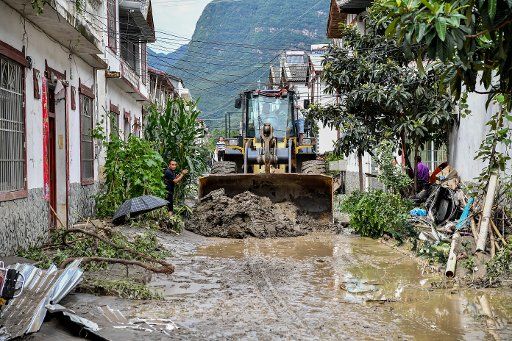 (180712) -- BEICHUAN, July 12, 2018 (Xinhua) -- People clear mud on the street in Chenjiaba Town of Beichuan County, southwest China\
