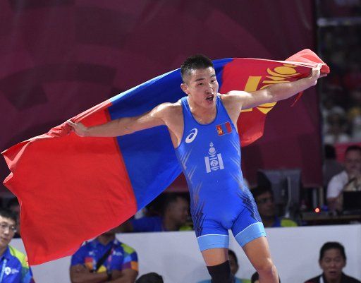 (180819) -- JAKARTA, Aug. 19, 2018 (Xinhua) -- Bekhbayar Erdenebat of Mongolia celebrates after winning the gold medal of Men\