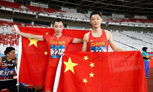 (180826) -- JAKARTA, Aug. 26, 2018 (Xinhua) -- Wang Jianan (R) of China and his teammate Zhang Yaoguang celebrate after the men\