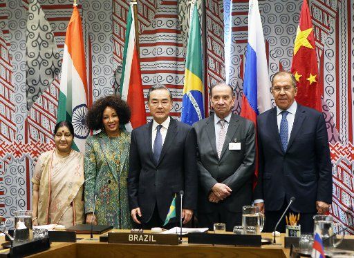 (180928) -- UNITED NATIONS, Sep. 28, 2018 (Xinhua) -- Chinese State Councilor and Foreign Minister Wang Yi (C) poses for a group photo with Indian External Affairs Minister Sushma Swaraj (1st L), South African Minister of International Relations and Cooperation Lindiwe Sisulu (2nd L), Brazilian Foreign Minister Aloysio Nunes (2nd R) and Russian Foreign Minister Sergey Lavrov before their meeting at the UN headquarters in New York, on Sept. 27, 2018. Foreign ministers of Brazil, Russia, India, China and South Africa (BRICS) vowed on Thursday to uphold multilateralism, safeguard international law and rules, object to unilateralism and protectionism, and push globalization toward a more balanced, just and inclusive development. (Xinhua\/Qin Lang) (qxy)