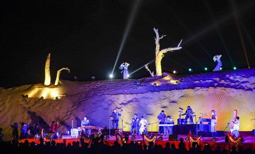 (181021) -- QIEMO, Oct. 21, 2018 (Xinhua) -- People play musical instruments during a desert themed concert held in Qiemo County in the Mongolian Autonomous Prefecture of Bayingolin, northwest China\