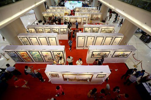 (181121) -- YANGON, Nov. 21, 2018 (Xinhua) -- People visit an art exhibition entitled "Myanmar: Through the Dragon\
