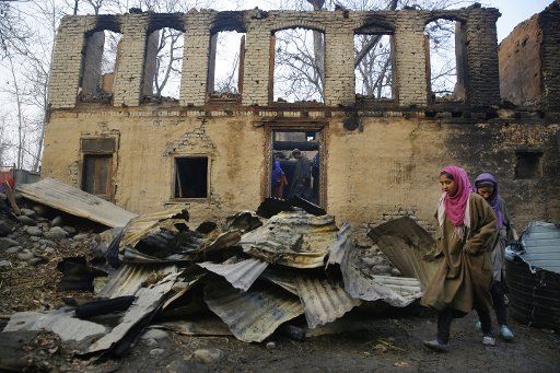 (181125) -- SRINAGAR, Nov. 25, 2018 (Xinhua) -- People inspect debris of a house, which was burnt during a gunfight between militants and joint contingents of police and army at village Kapran-Batagund, about 65km south of Srinagar city, the summer capital of Indian-controlled Kashmir, Nov. 25, 2018. At least six militants and a trooper were killed Sunday in a predawn fierce gunfight in restive Indian-controlled Kashmir, police said. (Xinhua\/Javed Dar)