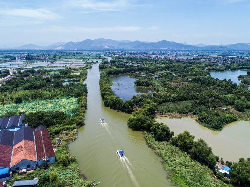 (190110) -- BEIJING, Jan. 10, 2019 (Xinhua) -- Aerial photo taken on July 10, 2018 shows "river chief", who is responsible for river resource protection, pollution prevention and control, and ecological restoration, inspecting a river with other officials at Baojian Village of Donglin Town in Huzhou City, east China\
