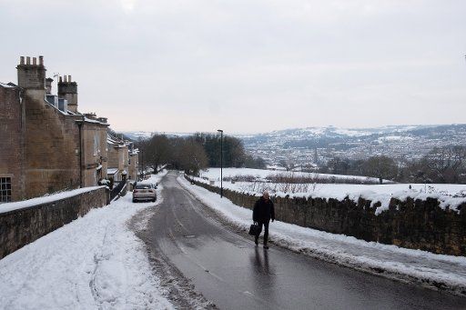 (190201) -- BATH (BRITAIN), Feb. 1, 2019 (Xinhua) -- A man walks up a snow-covered hill in Bath, Britain, on Feb. 1, 2019. The Met Office on Friday issued a yellow warning for snow and ice after some parts of Britain experienced the coldest night in seven years on Thursday. A severe cold snap is gripping Britain with snow and ice covering vast expanses of the nation. (Xinhua\/Ray Tang)
