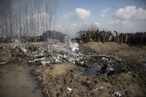 (190227) -- SRINAGAR, Feb. 27, 2019 (Xinhua) -- People and Indian army gather near the wreckage of an Indian aircraft after it crashed at village Garend Kalan of Budgam, about 34 km south of Srinagar city, the summer capital of Indian-controlled Kashmir, Feb. 27, 2019. A pilot and a co-pilot of Indian Air Force (IAF) were killed after a Mi-17 jet crashed Wednesday in Indian-controlled Kashmir, Indian officials said. Meanwhile, Pakistan army said on Wednesday the Pakistan Air Force has shot down two Indian fighter jets inside Pakistani airspace and ground troops arrested one pilot of the destroyed jet, according to a military statement. (Xinhua\/Javed Dar)