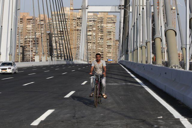 (190515) -- CAIRO, May 15, 2019 (Xinhua) -- A man rides a bike on Rod al-Farag Axis Bridge in Cairo, Egypt, on May 15, 2019. Egyptian President Abdel Fattah al-Sisi attended on Wednesday the opening of Rod al-Farag Axis Bridge, the widest suspension bridge in the world, state-run Nile TV reported. (Xinhua\/Ahmed Gomaa
