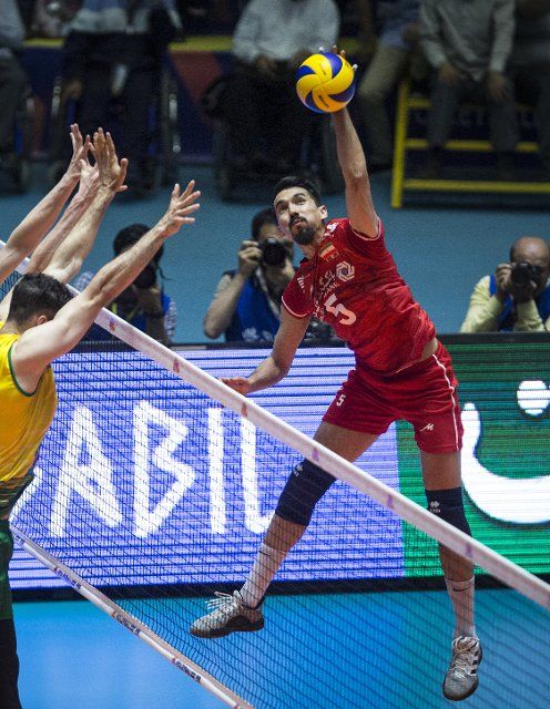 (190623) -- ARDABIL, June 23, 2019 (Xinhua) -- Farhad Ghaemi (R) of Iran spikes the ball during the FIVB Volleyball Nations League match between Iran and Australia in Ardabil, Iran, June 22, 2019. (Xinhua\/Ahmad Halabisaz
