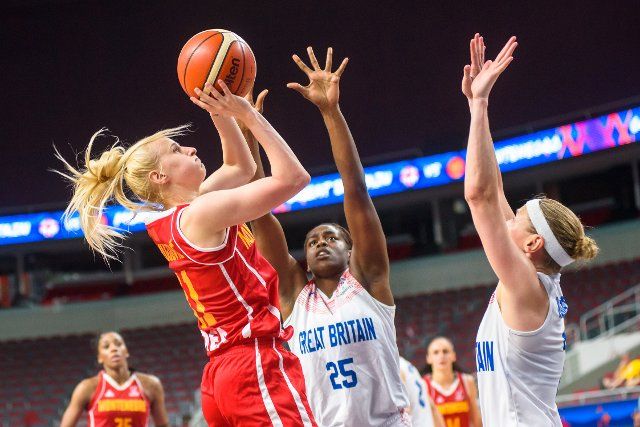 (190702) -- RIGA, July 2, 2019 (Xinhua) -- Buzica Mujovic (L) of Montenegro competes with Cheridene Green (C) of Britain during the qualification match to quarterfinal between Britain and Montenegro at the FIBA Women\