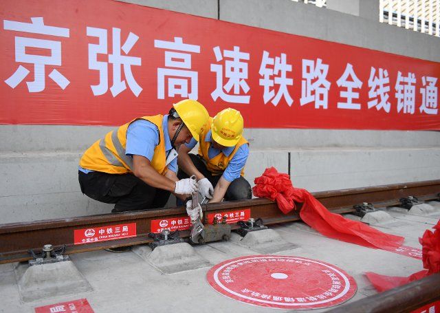 (190614) -- BEIJING, June 14, 2019 (Xinhua) -- Constructors work on the track of the Beijing-Zhangjiakou High-Speed Railway in a tunnel in Beijing, capital of China, on June 12, 2019. With the last steel rail piece laid Wednesday in a tunnel underground the Tsinghua University in Beijing, the track of the whole length of the Beijing-Zhangjiakou High-Speed Railway has been built. The original railway linking the two cities, known as China\