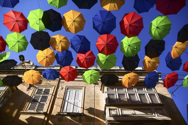 (190714) -- ZABBAR, July 14, 2019 (Xinhua) -- Photo taken on July 13, 2019 shows umbrellas suspended in the air along a street to bring back the popular "Umbrella Street" spectacle in Zabbar, Malta. (Xinhua\/Jonathan Borg)
