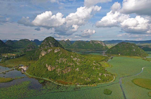 (190807) -- QIUBEI, Aug. 7, 2019 (Xinhua) -- Aerial photo taken on Aug. 6, 2019 shows the scenery at the Puzhehei national wetland park in Qiubei County, southwest China\