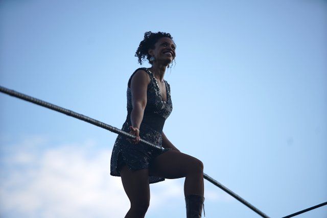 (190814) -- PRAGUE, Aug. 14, 2019 (Xinhua) -- French rope walker Tatiana-Mosio Bongonga walks on a rope in Prague, the Czech Republic, on Aug. 14, 2019. Tatiana-Mosio Bongonga from the French troup Cie Basinga Wednesday crossed the Vltava River on a 350-meter-long rope at the height of 35 meters in Prague. She crossed the river without any visible protection, using a four-metre-long balance pole weighing 12 kg. The whole journey took her about 40 minutes. (Photo by Dana Kesnerova\/Xinhua)