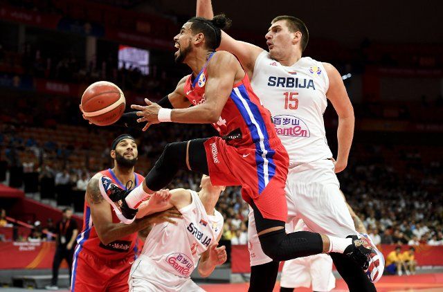 (190906) -- WUHAN, Sept. 6, 2019 (Xinhua) -- Gian Clavell (Top L) of Puerto Rico goes up to the basket past Nikola Jokic (Top R) of Serbia during the group J match between Serbia and Puerto Rico at the 2019 FIBA World Cup in Wuhan, capital of central China\