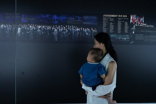 (190918) -- NANJING, Sept. 18, 2019 (Xinhua) -- Visitors view a photo exhibition marking the 71st anniversary of the Tokyo Trial\