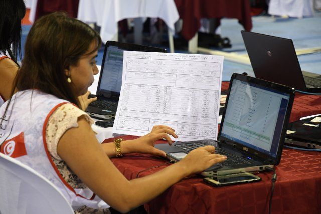 (190916) -- TUNIS, Sept. 16, 2019 (Xinhua) -- A staff member of the Independent High Authority for Elections (ISIE) counts the votes of the presidential election at the counting center in Tunis, Tunisia, Sept. 16, 2019. The participation rate in the first round of presidential elections in Tunisia reached 45.02 percent, announced Sunday evening by Nabil Bafoun, president of the Independent High Authority for Elections (ISIE). According to the ISIE, preliminary results of the election will be announced on Sept. 17. Tunisians voted for a new president to succeed the former President Beji Caid Essebsi, who died on July 25. (Photo by Adele Ezzine\/Xinhua)