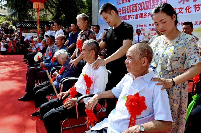 (191007) -- WUYISHAN, Oct. 7, 2019 (Xinhua) -- People give massage to the elderly during celebrations for the Chongyang Festival in Xijiao Village of Xingtian Township of Wuyishan City, southeast China\