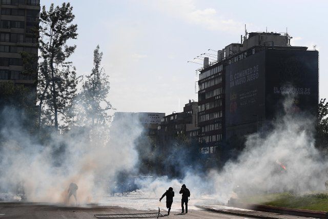(191021) -- SANTIAGO, Oct. 21, 2019 (Xinhua) -- People participate in a protest in Santiago, Chile, Oct. 19, 2019. Chile on Sunday extended a state of emergency to regions swept by violent protests, which caused at least three deaths and 716 arrests, authorities said. The protests, sparked by public transit fare hikes, began in the capital and spread to other regions across the country. The state of emergency is in effect in the capital and other regions of Coquimbo, Valparaiso and Metropolitana. (Xinhua\/Jorge Villegas